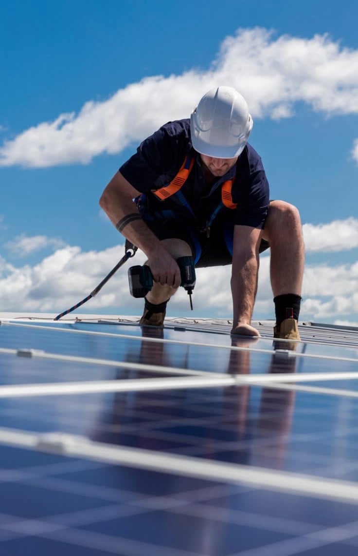 Technician cleaning rooftop solar panels